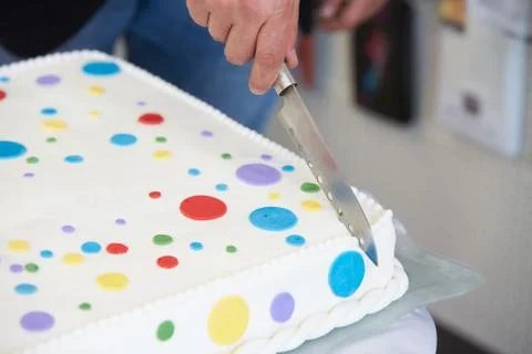 Detail of man's hand who is cutting cake at the opening ceremony Stock Photos