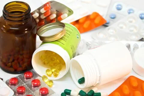 Detail of medicine bottles with spilled pills. Stock Photos