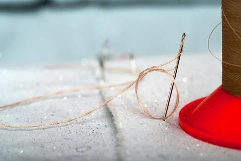 Detail of a needle with thread in the workroom tailor Stock Photos