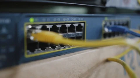 Detail of network cable being plugged into networking switchboard Video stock 101685382