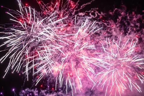 Detail of New Year's fireworks in Prague - pink rockets and sparks. Stock Photos