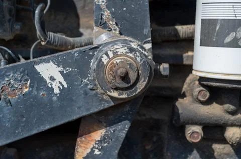 Detail of old tractor and mechanical pivot arm with grease zerk Stock Photos