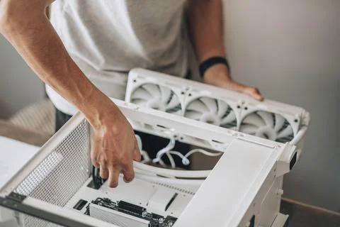 A detail-oriented computer technician, engaged in the delicate process of Stock Photos