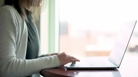 A detail-oriented shot of a young professional woman engaged in her work on a Video stock 274516550