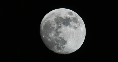 Detail of a partial almost full moon in the night sky Video stock 152366879
