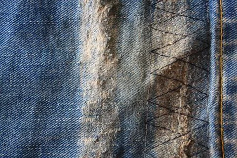 Detail of a patch in blue jeans Stock Photos