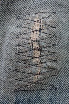 Detail of a patch in blue jeans Stock Photos