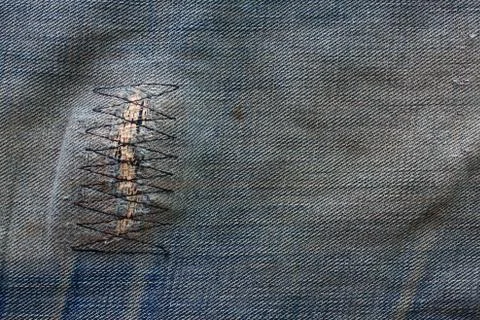 Detail of a patch in blue jeans Stock Photos