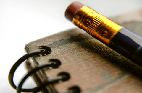 Detail of a pencil on a notebook . Stock Photos