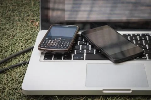 Detail of phones on computer keyboard Stock Photos