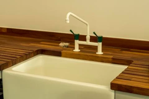 Detail of a rectangular kitchen sink with water tap Stock Photos