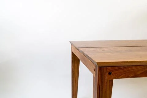 Detail of a rectangular wooden table isolated in a white setting Stock Photos