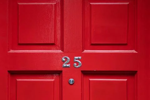 Detail of a red door with number Stock Photos