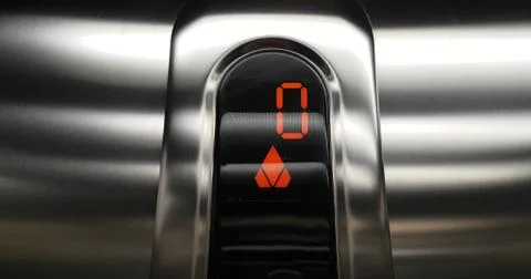 Detail of red led with number zero of elevator that go up from zero to first  스톡 사진