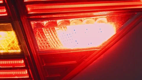 Detail of red metallized black rear car headlight in eye shape. Stock Footage 106928614