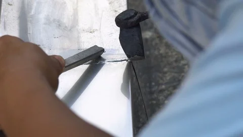 Detail of a roofer welding stainless gutter Stock Footage 73309796