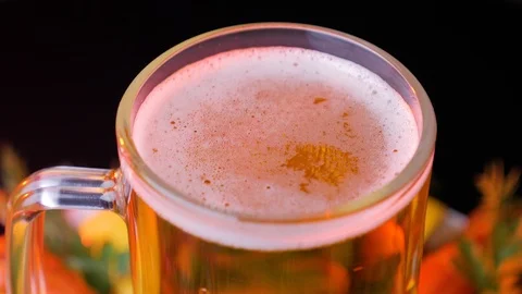 Detail of rotating beer glass with bubbles. Close up beer background. Video stock 125931053