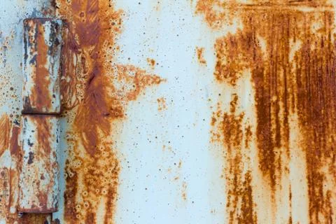 Detail of a rusty door on rusty hinges.Rust background with scratches and rem Stock Photos