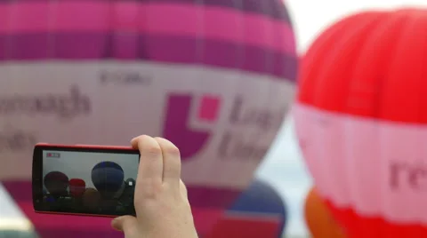 Detail of the screen of a mobile device used to film coloured balloons Stock Footage 59938889