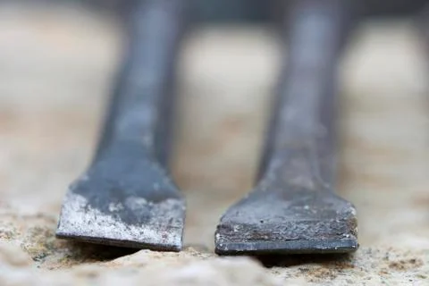 Detail from the sharp edge of two used black chisel. Stock Photos