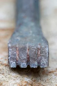 Detail from the sharp edge of a used black chisel. Stock Photos