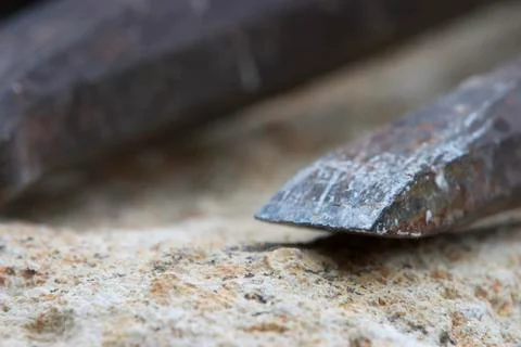Detail from the sharp edge of a used black chisel. Stock Photos