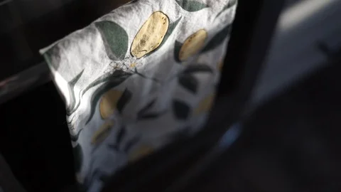 Detail shot of happy lemon patterned tea towel in sunny kitchen Stock-Footage 128334022