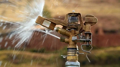 Detail Shot Irrigation System Head and Water Flowing over Rural Background Stock Footage 110331302