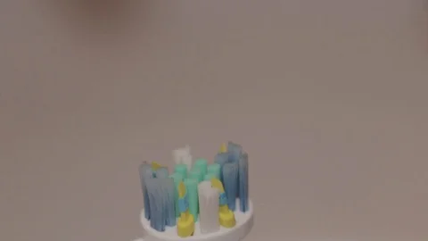 Detail shot of mint toothpaste layered on an electric toothbrush. Stock Footage 104404680