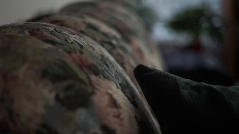 Detail shot of an old retro floral 60's couch fabric Stock Footage