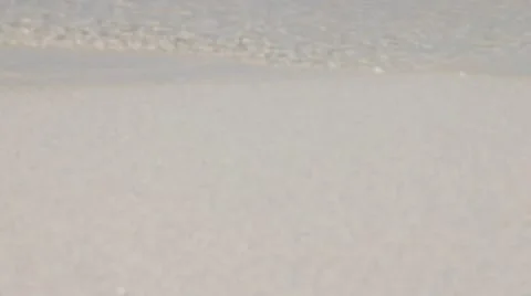 Detail shot from a small wave on the sandy beach Video stock 40272522