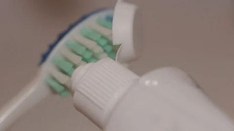 Detail shot of toothpaste being put on a toothbrush. Stock Footage 104404712