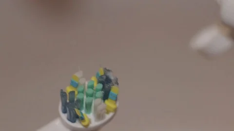 Detail shot of toothpaste put on an electric toothbrush. Stock Footage 104404695