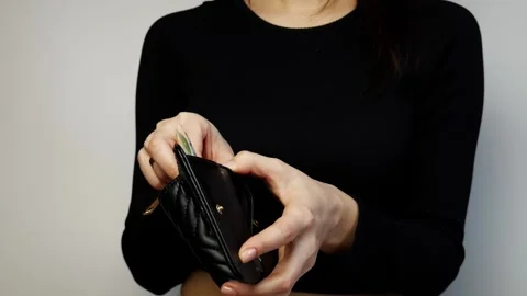 Detail shot of women's hands pulling money out of a black wallet. Stock Footage 305821671