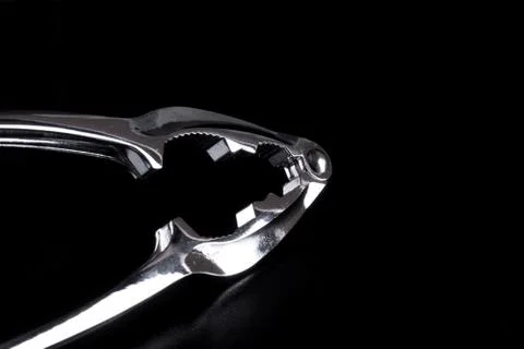 Detail of a silver lucent nutcracker on black background Stock Photos