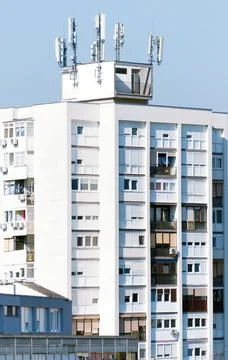 Detail of a skyscraper with apartments and antenna on the roof Stock Photos