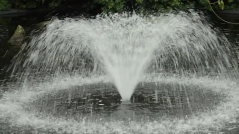 Detail of a small waterfall flowing down a stone wall in a park Stock Footage 250147261