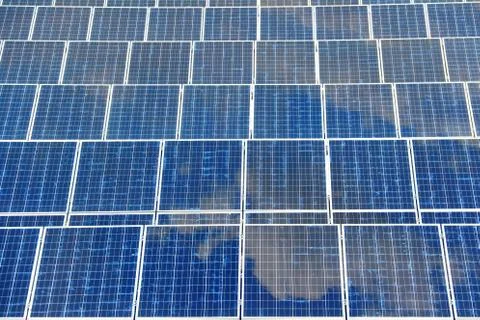 Detail of solar panel with reflection blue sky. Solar panel texture. Stock Photos