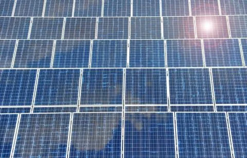 Detail of solar panel with reflection blue sky and sunlight. Stock Photos