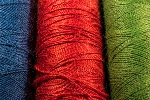 Detail of spools of threads, blue, red, green Stock Photos