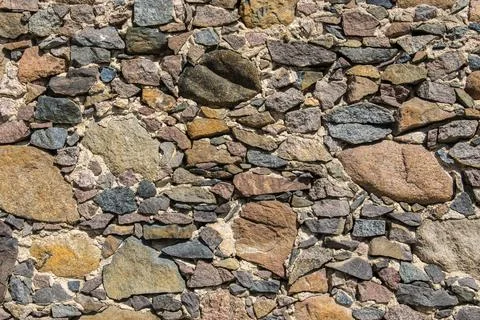 Detail of a stone wall with different size of rocks. Stock Photos