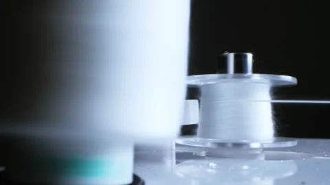 Detail. the thread from the spool is wound on the bobbin on the sewing machine Video stock 141879987