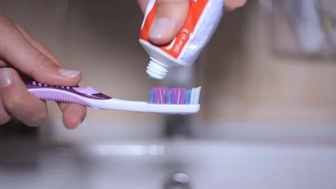Detail of toothpaste being squeezed on to a toothbrush Stock Footage 76395321