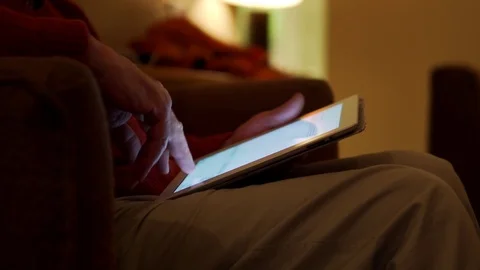 Detail of a Touchscreen Tablet Used at Night by Man, Light Illuminating Fingers Stock Footage