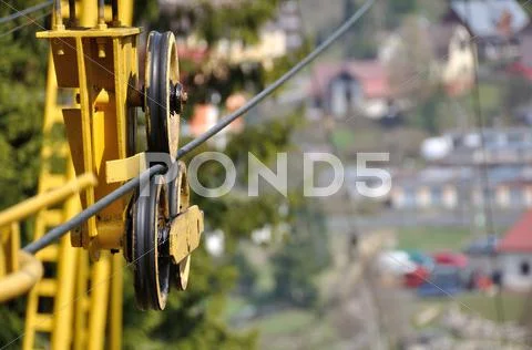 Detail of tow rope with wheels and yellow construction from cableway mechanism Stock Photos