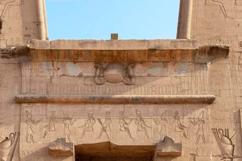 Detail of upper side of main entrance to temple of Horus at Edfu - Egypt Stock Photos