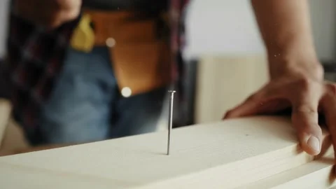 Detail video of carpenter using a hammer to drive nail. Stock Footage 136724491
