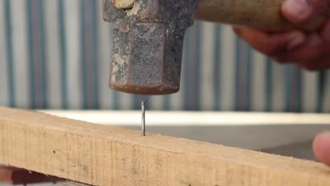 Detail video of carpenter using a hammer to drive nail. Stock Footage 144091053