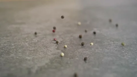 Detail video of colored pepper falling on a kitchen counter. 動画素材 148853018
