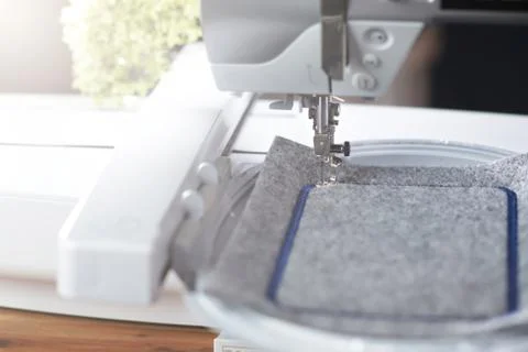 Detail view on a modern computerised sewing machine with embroidery unit Stock Photos